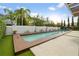 Long rectangular pool with wood deck and tropical landscaping at 8558 Morehouse Dr, Orlando, FL 32836