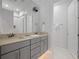 Bright bathroom with double vanity and gray cabinets at 900 Jack Nicklaus Ct, Kissimmee, FL 34747