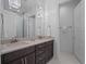 Spa-like bathroom with double vanity and chandelier at 900 Jack Nicklaus Ct, Kissimmee, FL 34747