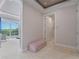 Elegant hallway with plush bench and access to a walk-in closet at 900 Jack Nicklaus Ct, Kissimmee, FL 34747