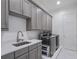 Laundry room with gray cabinets and quartz countertops at 900 Jack Nicklaus Ct, Kissimmee, FL 34747