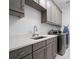 Laundry room with stylish gray cabinetry and quartz countertops at 900 Jack Nicklaus Ct, Kissimmee, FL 34747