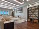 Bright living room featuring a sectional sofa, fireplace, and built-in shelving at 900 Jack Nicklaus Ct, Kissimmee, FL 34747