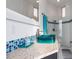 Modern bathroom with a teal sink and glass shower at 9138 Great Heron Cir, Orlando, FL 32836