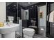 Modern bathroom with black and white tile, double sinks, and a toilet at 9138 Great Heron Cir, Orlando, FL 32836