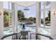 Breakfast nook with pool views, featuring a glass table and modern chairs at 9138 Great Heron Cir, Orlando, FL 32836