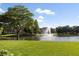 Serene lake view with lush landscaping and fountain at 9138 Great Heron Cir, Orlando, FL 32836