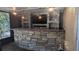 Curved stone bar with copper top, lighting, and shelving at 9913 Janette Ln, Clermont, FL 34711