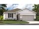 One-story home with a neutral color palette and landscaping at 1212 White Ash Loop, Deland, FL 32720