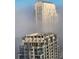 Modern high-rise buildings partially hidden by fog at 150 E Robinson St # 3104, Orlando, FL 32801