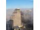 High-rise buildings in a cityscape partially covered in fog at 150 E Robinson St # 3104, Orlando, FL 32801