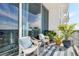 Peaceful balcony with white chairs and potted plants at 150 E Robinson St # 3104, Orlando, FL 32801