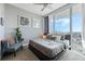 Bright bedroom with a large bed, city view, and comfy armchair at 150 E Robinson St # 3104, Orlando, FL 32801