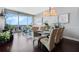 Bright dining area with glass table and modern chairs, hardwood floors, and city views at 150 E Robinson St # 3104, Orlando, FL 32801