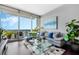 Spacious living room with large windows, city views, and comfortable gray couch at 150 E Robinson St # 3104, Orlando, FL 32801