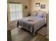 Bedroom with queen-size bed and decorative bedding at 156 Pine Cone Dr, Davenport, FL 33897