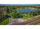 Community entrance with lake, fountain, and lush landscaping at 169 Magneta Loop, Auburndale, FL 33823