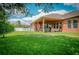 Spacious backyard with patio, lush lawn, and a covered lanai at 169 Magneta Loop, Auburndale, FL 33823