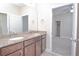 Bathroom with a large mirror, double sinks, granite countertops, and dark brown cabinets at 169 Magneta Loop, Auburndale, FL 33823