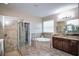 Luxurious bathroom with soaking tub, walk-in shower, and double vanity at 169 Magneta Loop, Auburndale, FL 33823