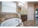 Bathroom features a garden tub, double vanity, and a large mirror at 169 Magneta Loop, Auburndale, FL 33823