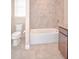 Bright bathroom offers a tiled shower, tub, tile flooring, and vanity at 169 Magneta Loop, Auburndale, FL 33823