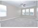 Large bedroom with ample natural light, neutral walls, and plush gray carpeting at 169 Magneta Loop, Auburndale, FL 33823
