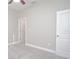 Neutrally decorated bedroom with carpet flooring, white doors, and fan at 169 Magneta Loop, Auburndale, FL 33823