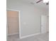Bedroom with neutral walls, carpet, white trim, and closet at 169 Magneta Loop, Auburndale, FL 33823