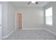Carpeted bedroom with a window and a door that opens to a closet with shelving at 169 Magneta Loop, Auburndale, FL 33823