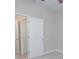 Carpeted bedroom with base molding and paneled doors to a bathroom and closet at 169 Magneta Loop, Auburndale, FL 33823
