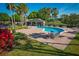 Relaxing community pool with lounge chairs and a shaded seating area at 169 Magneta Loop, Auburndale, FL 33823