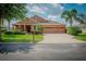 Attractive one-story home with three-car garage and manicured lawn at 169 Magneta Loop, Auburndale, FL 33823