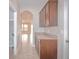 Hallway featuring tile floor, arched entry, and butler's pantry with granite countertop and cabinets at 169 Magneta Loop, Auburndale, FL 33823