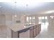 Open-concept kitchen island with granite countertops, stainless steel appliances, and eat-in space at 169 Magneta Loop, Auburndale, FL 33823