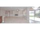 Bright, open living room featuring a fireplace, built-in shelving, and a sliding glass door at 169 Magneta Loop, Auburndale, FL 33823
