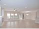 Spacious living area with tile flooring, ceiling fan, and views of the outdoor patio at 169 Magneta Loop, Auburndale, FL 33823