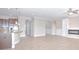 Open-concept living space featuring a modern fireplace, tile floors, and a kitchen island at 169 Magneta Loop, Auburndale, FL 33823