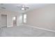 Bright primary bedroom featuring carpet floors, ensuite bathroom, and large windows at 169 Magneta Loop, Auburndale, FL 33823