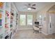 Home office with built-in shelving and a desk, providing ample workspace at 169 Magneta Loop, Auburndale, FL 33823