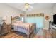 Spacious bedroom with wood floors and an ornate metal bed frame at 17478 Se 115Th Terrace Rd, Summerfield, FL 34491
