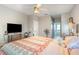 Comfortable bedroom with ceiling fan and en-suite bathroom access at 17478 Se 115Th Terrace Rd, Summerfield, FL 34491