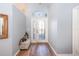 Bright entryway with hardwood floors and a bench at 17478 Se 115Th Terrace Rd, Summerfield, FL 34491