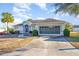 Single-story house with a screened garage and landscaped yard at 17478 Se 115Th Terrace Rd, Summerfield, FL 34491
