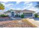 Single-story house with a screened garage and landscaped yard at 17478 Se 115Th Terrace Rd, Summerfield, FL 34491