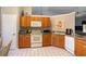 Bright kitchen with wood cabinets, tile floor, and modern appliances at 17478 Se 115Th Terrace Rd, Summerfield, FL 34491
