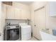 Laundry room with washer, dryer, cabinets and utility sink at 17478 Se 115Th Terrace Rd, Summerfield, FL 34491
