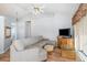 Living room with sectional sofa, wood floors and a window at 17478 Se 115Th Terrace Rd, Summerfield, FL 34491
