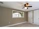 Serene bedroom with large window and ceiling fan at 1778 Cr 426, Lake Panasoffkee, FL 33538