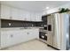 Modern kitchen with stainless steel appliances and white cabinets at 1778 Cr 426, Lake Panasoffkee, FL 33538